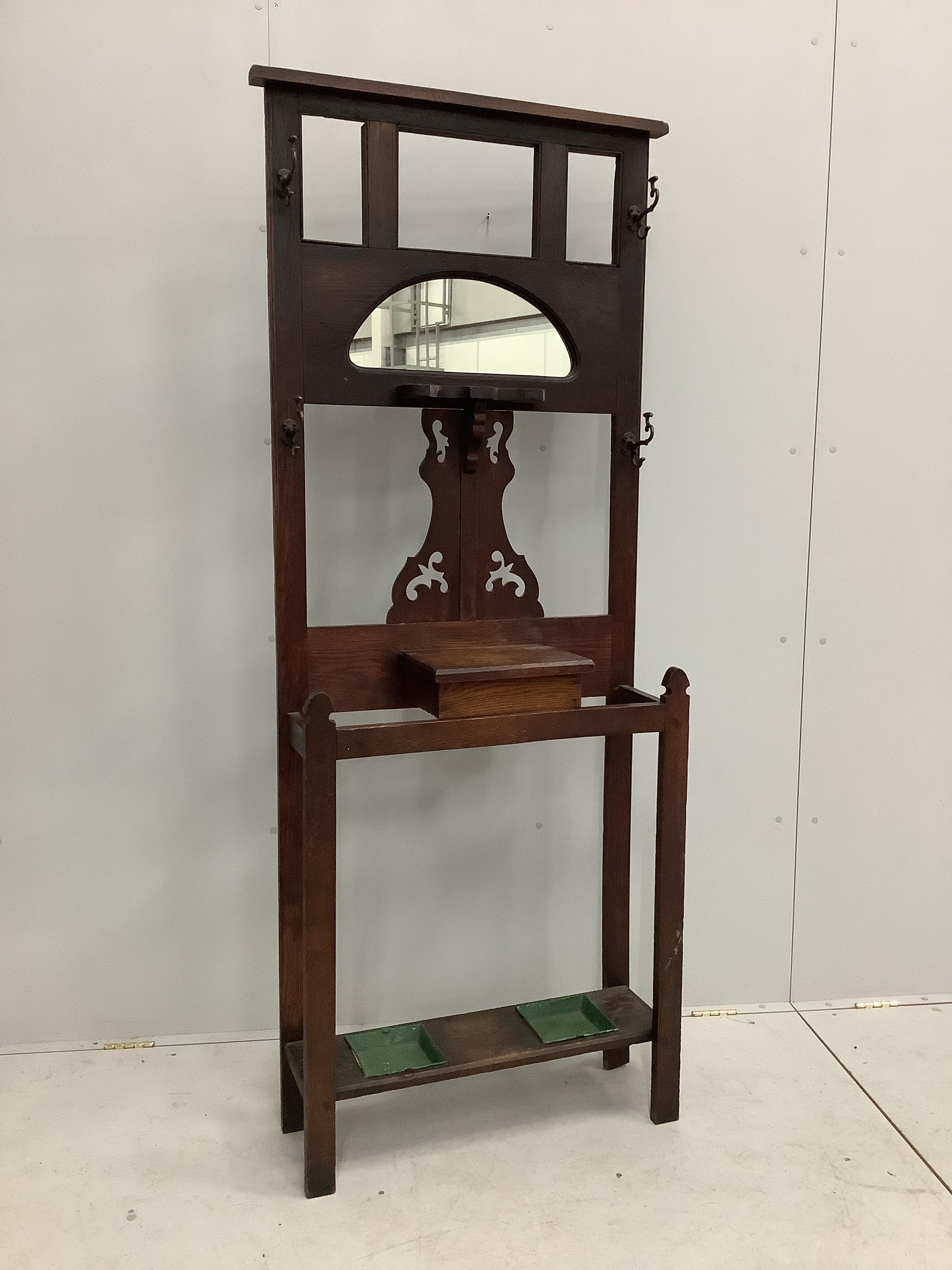 A late Victorian oak hall stand, width 80cm, height 195cm